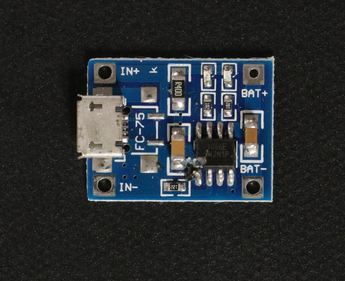 A small printed circuit board with a burnt spot.